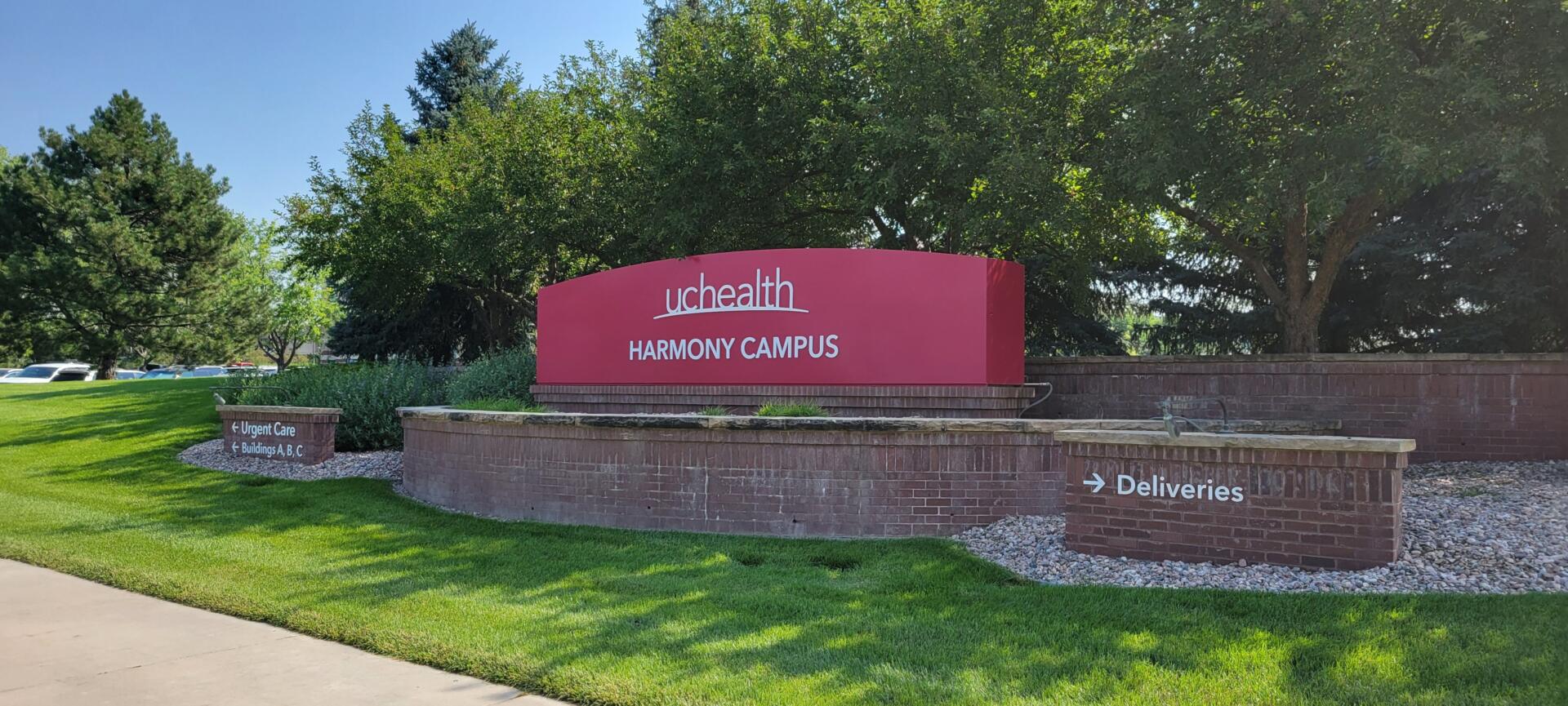 UCHealth Harmony Campus entrance sign with trees in the background.