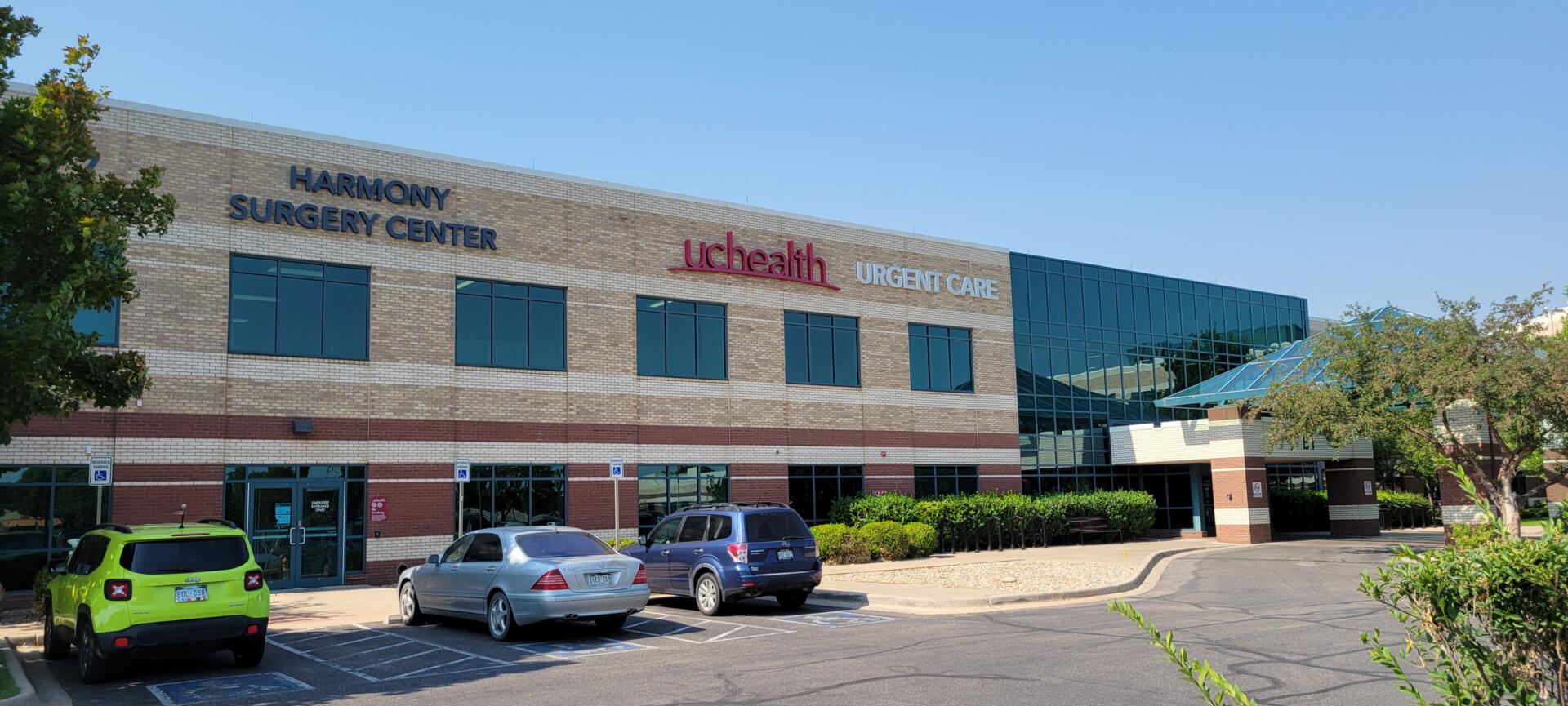 Harmony Surgery Center building with parked cars in front.